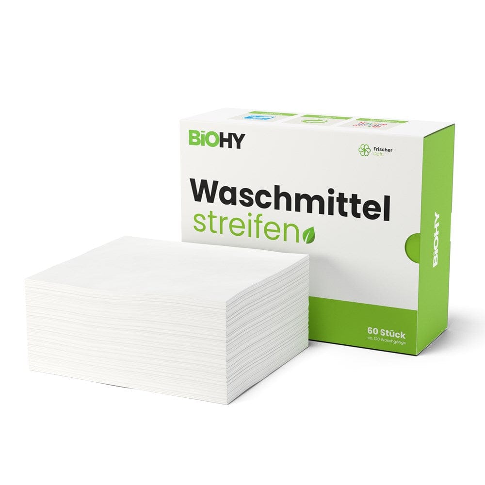Weisse waschmittelstreifen mit grün-weisser Kartonverpackung