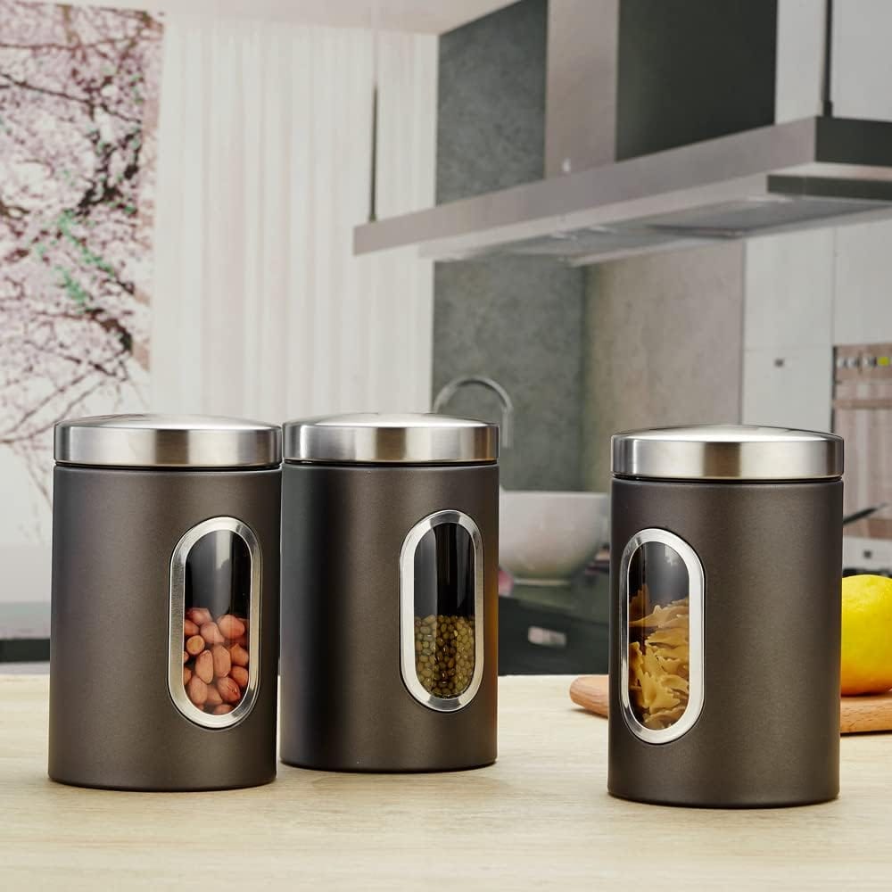 Drei graue Kaffeedosen mit transparenter Vorderseite, silbernem Deckel und Beispielsinhalten